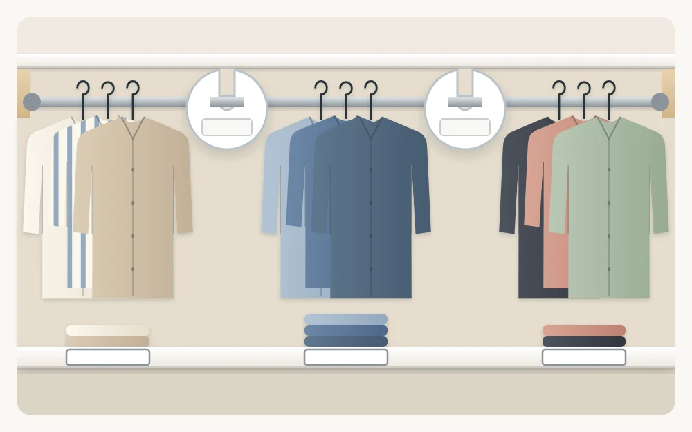 A closet rod with hanging shirts and two round blank divider discs separating the garments into three groups
