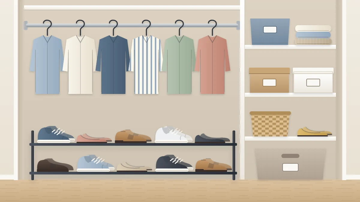 A low two-tier shoe rack with pairs of sneakers, flats and loafers under short hanging shirts, and two lidded shoe boxes on a shelf