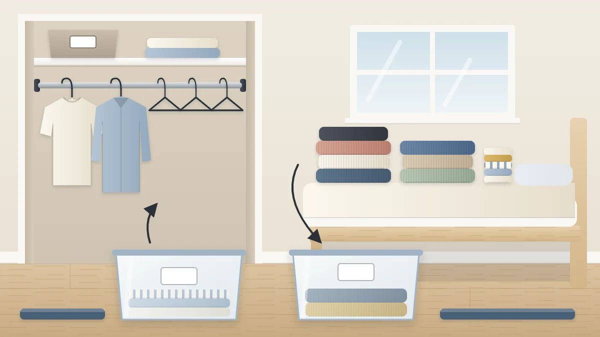 A bedroom mid-switch: an open closet with half its rod empty, stacks of sweaters and T-shirts on the bed, and two open storage bins on the floor